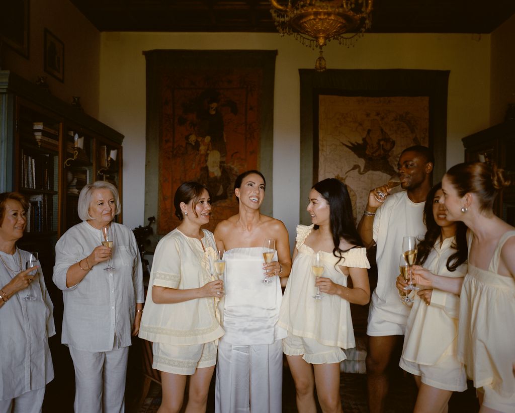 “Getting ready with my bridesmaids bridesman my mother and my motherinlaw. I gifted my bridal party butteryellow PJs...