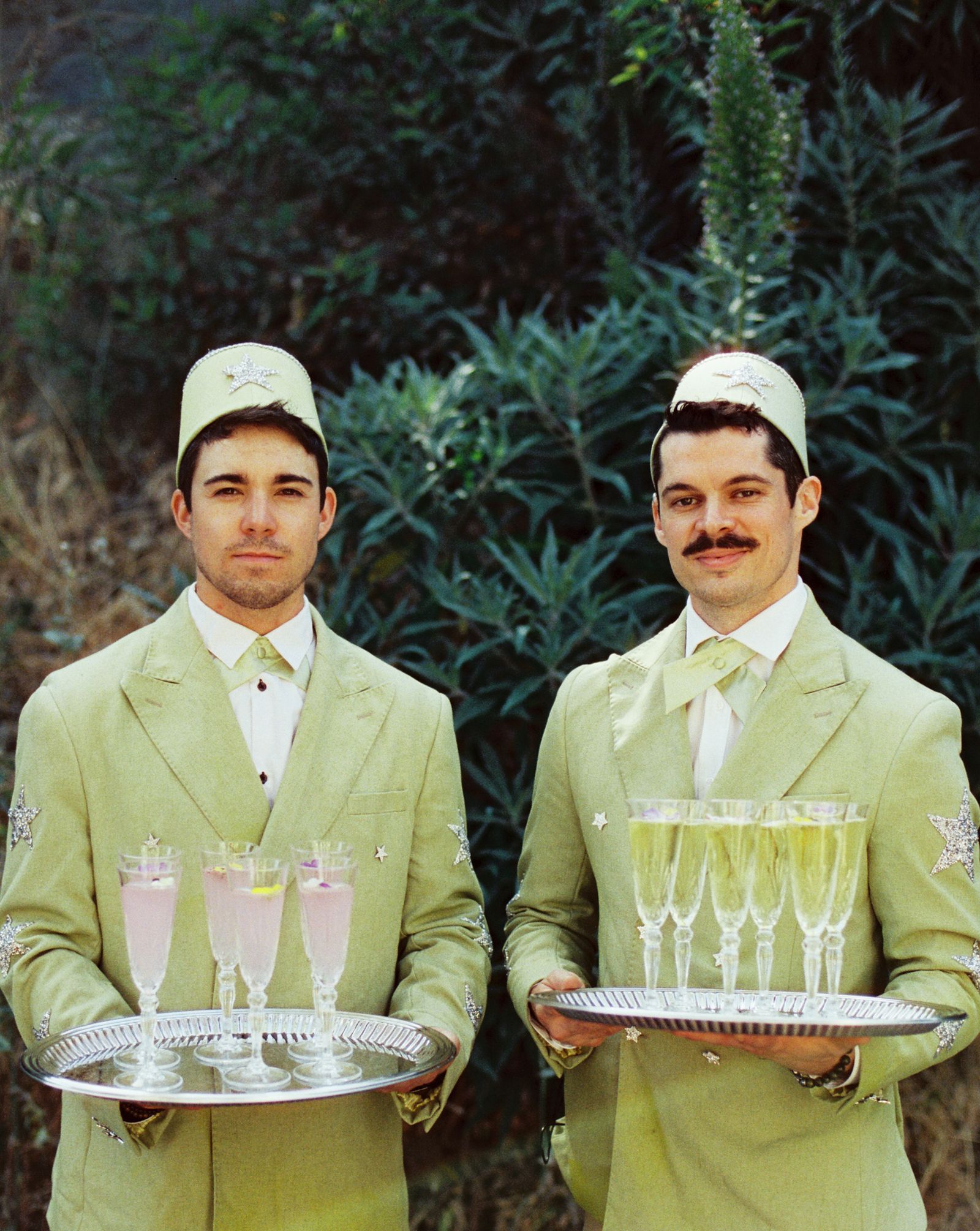 Image may contain Adult Person Clothing Hat Accessories Formal Wear Tie Waiter and People