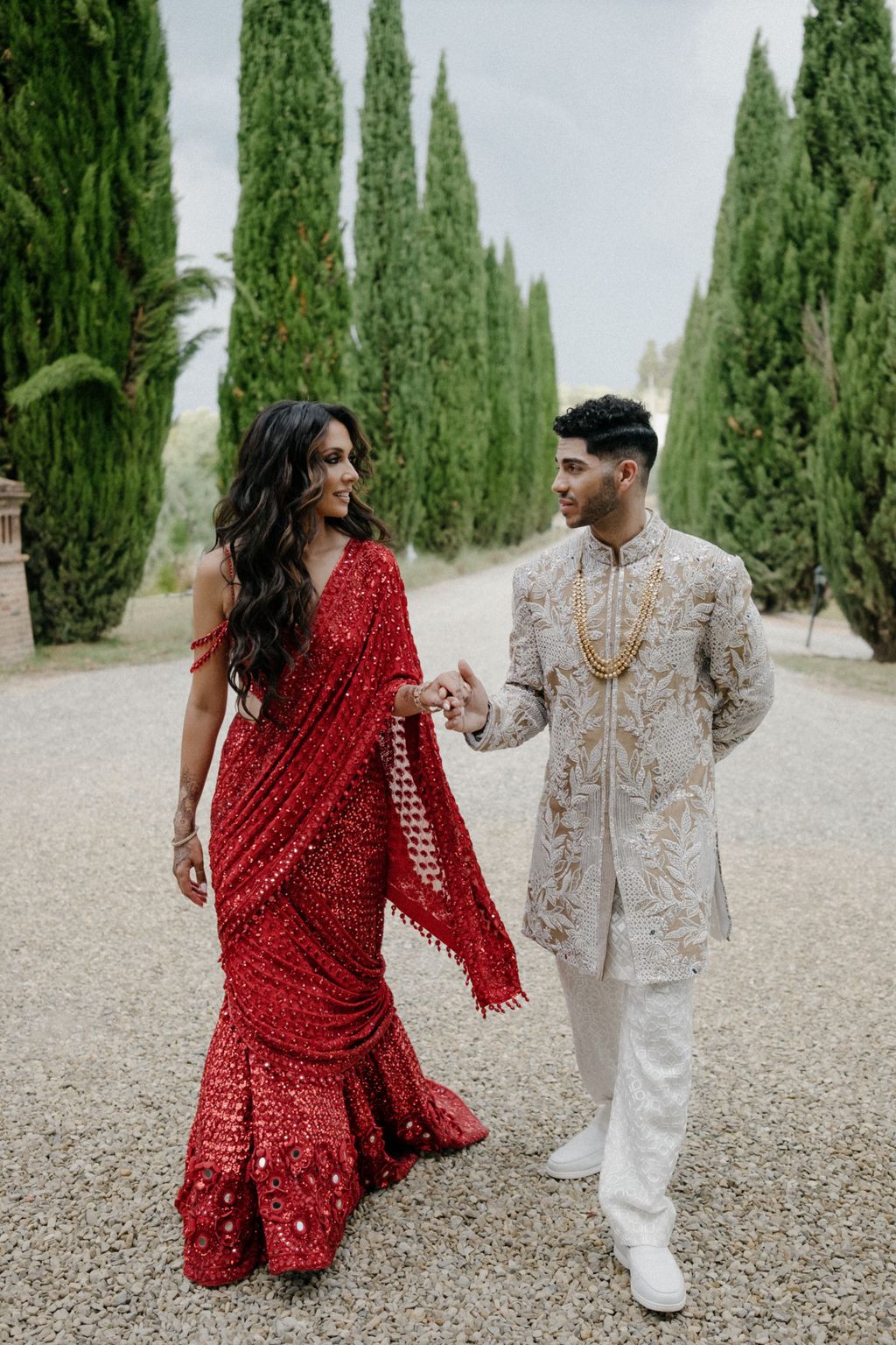 Image may contain Mena Massoud Body Part Hand Person Adult Holding Hands Clothing Footwear Shoe and Wedding