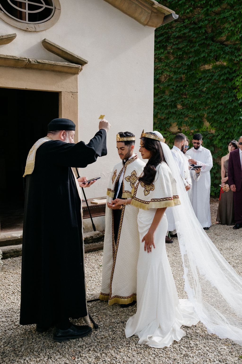 Image may contain Mena Massoud Adult Person Clothing Hat Footwear Shoe Wedding Fashion Dress and Electronics