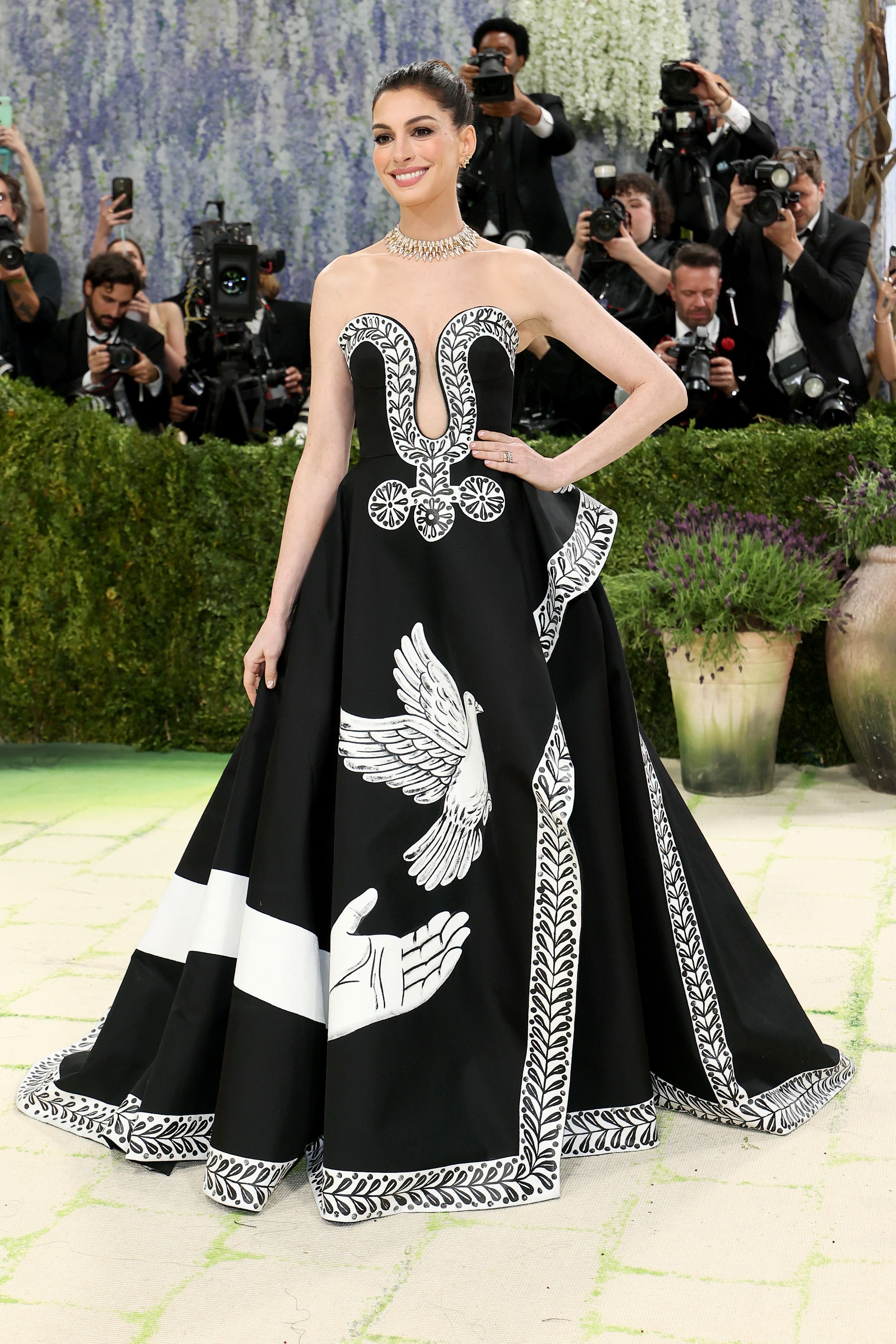Image may contain Anne Hathaway Clothing Dress Formal Wear Fashion Gown Person Adult Wedding and Wedding Gown
