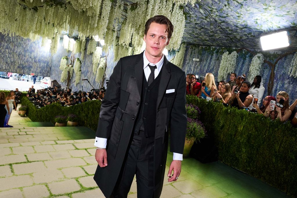 Image may contain Bill Skarsgård Marcus Murphy Clothing Formal Wear Suit Coat Tuxedo Adult Person and Blazer