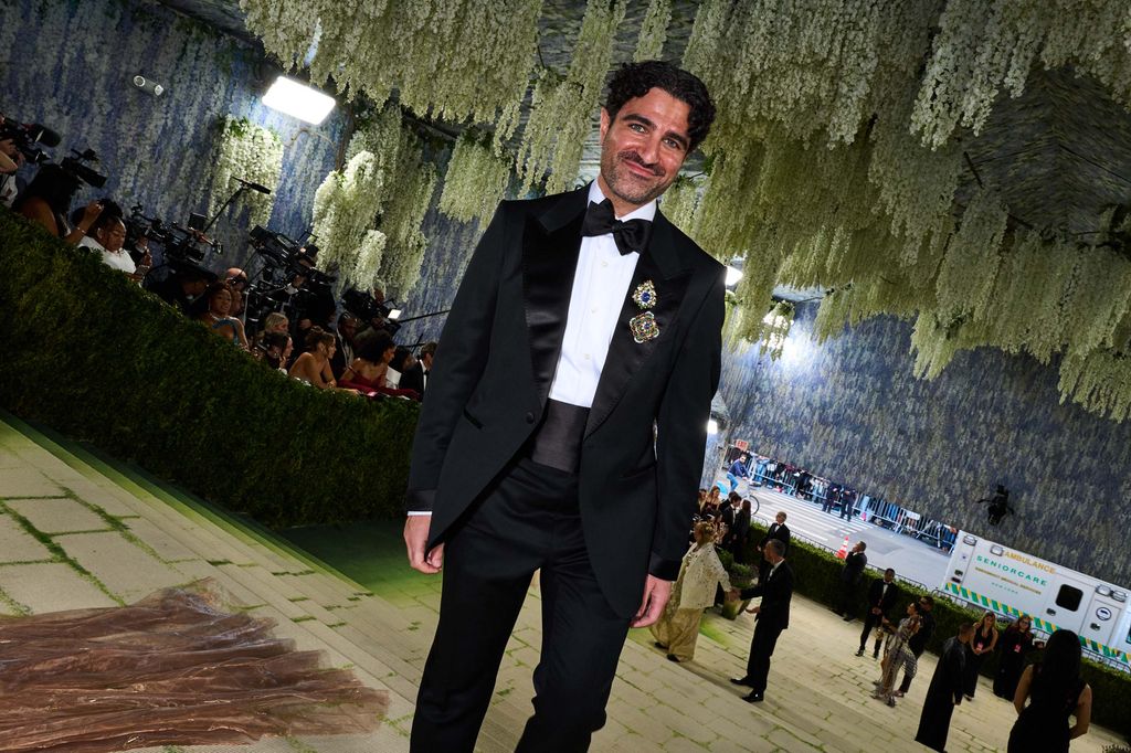 Image may contain Clothing Formal Wear Suit Blazer Coat Jacket Tuxedo Face Head Person Photography and Portrait