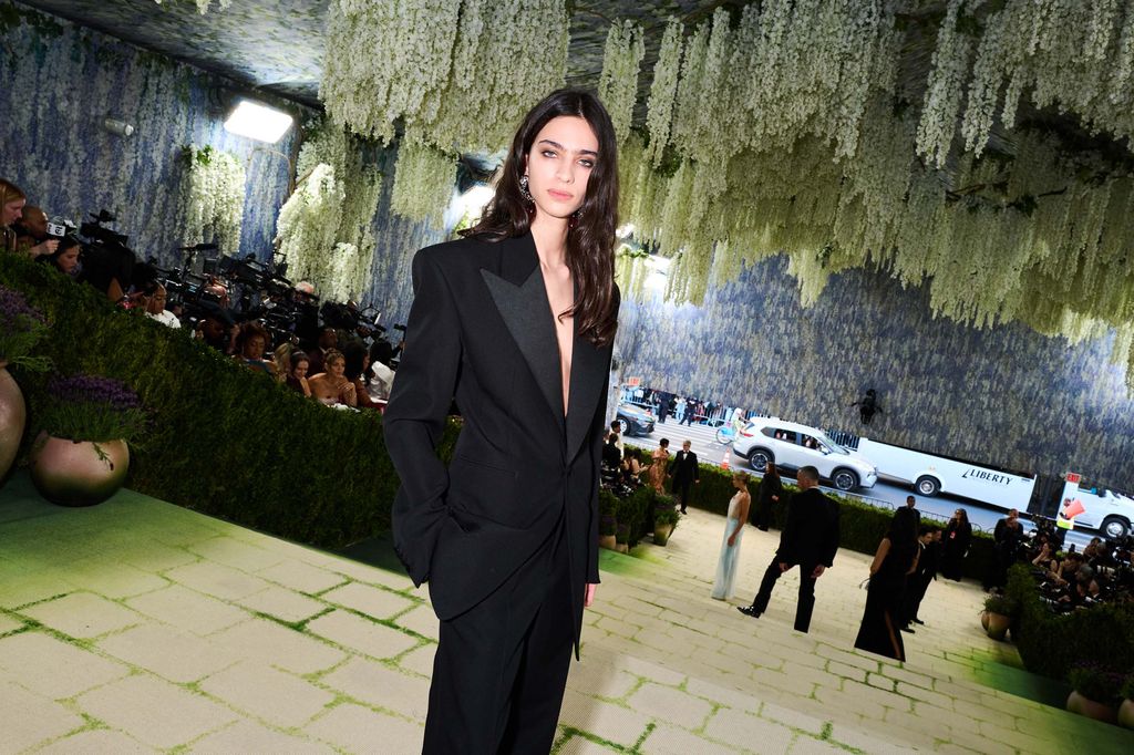 Image may contain Clothing Formal Wear Suit Blazer Coat Jacket Black Hair Hair Person Adult Face and Head