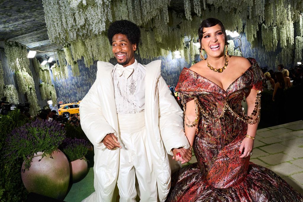 Image may contain Jon Batiste Adult Person Wedding Accessories Jewelry Necklace Face Head Blazer and Clothing