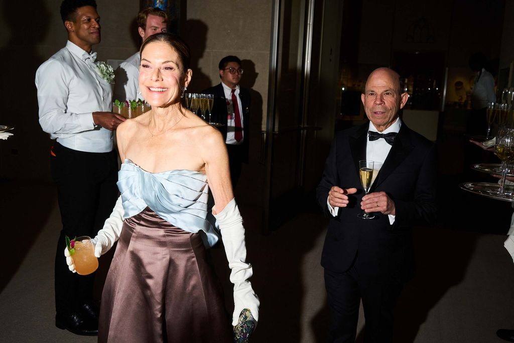 Image may contain Blazer Clothing Coat Jacket Formal Wear Fashion Suit Person Photobombing Accessories and Tie